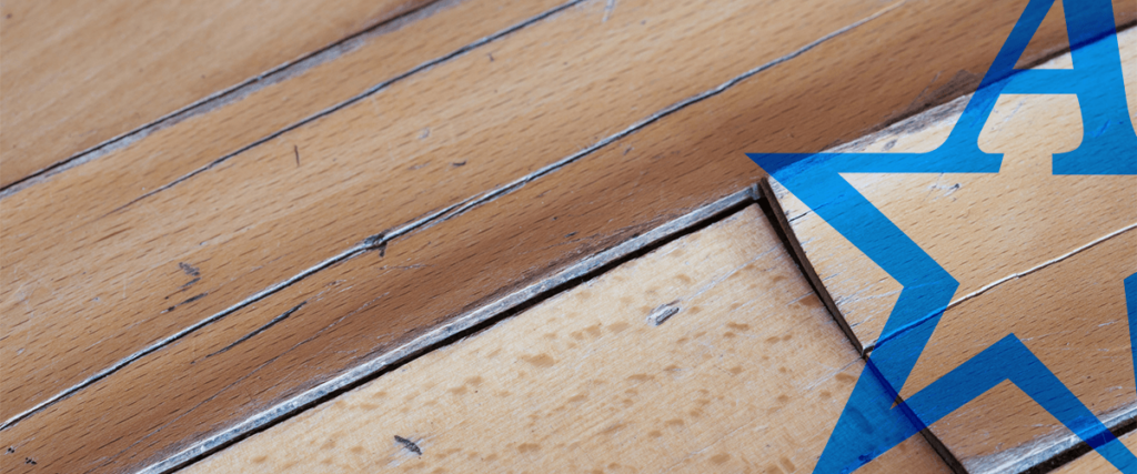 a blue star is painted on a wooden surface