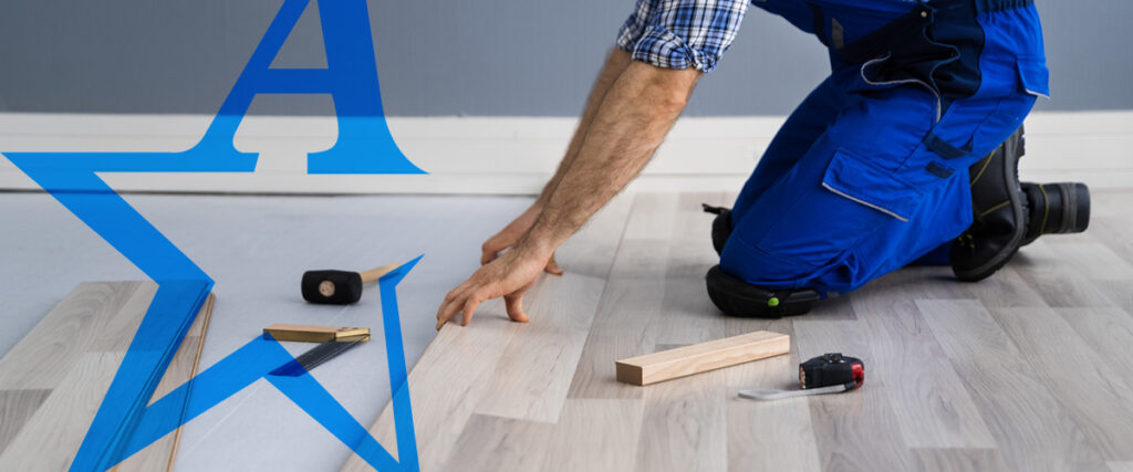 a man is kneeling on the floor with a blue star in the background